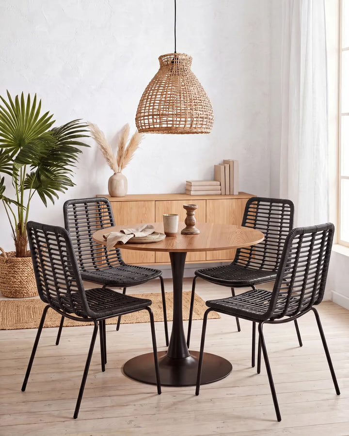 Two black metal dining chairs with woven slatted backs and seats.