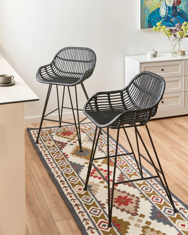 Black rattan chairs with sturdy iron frames