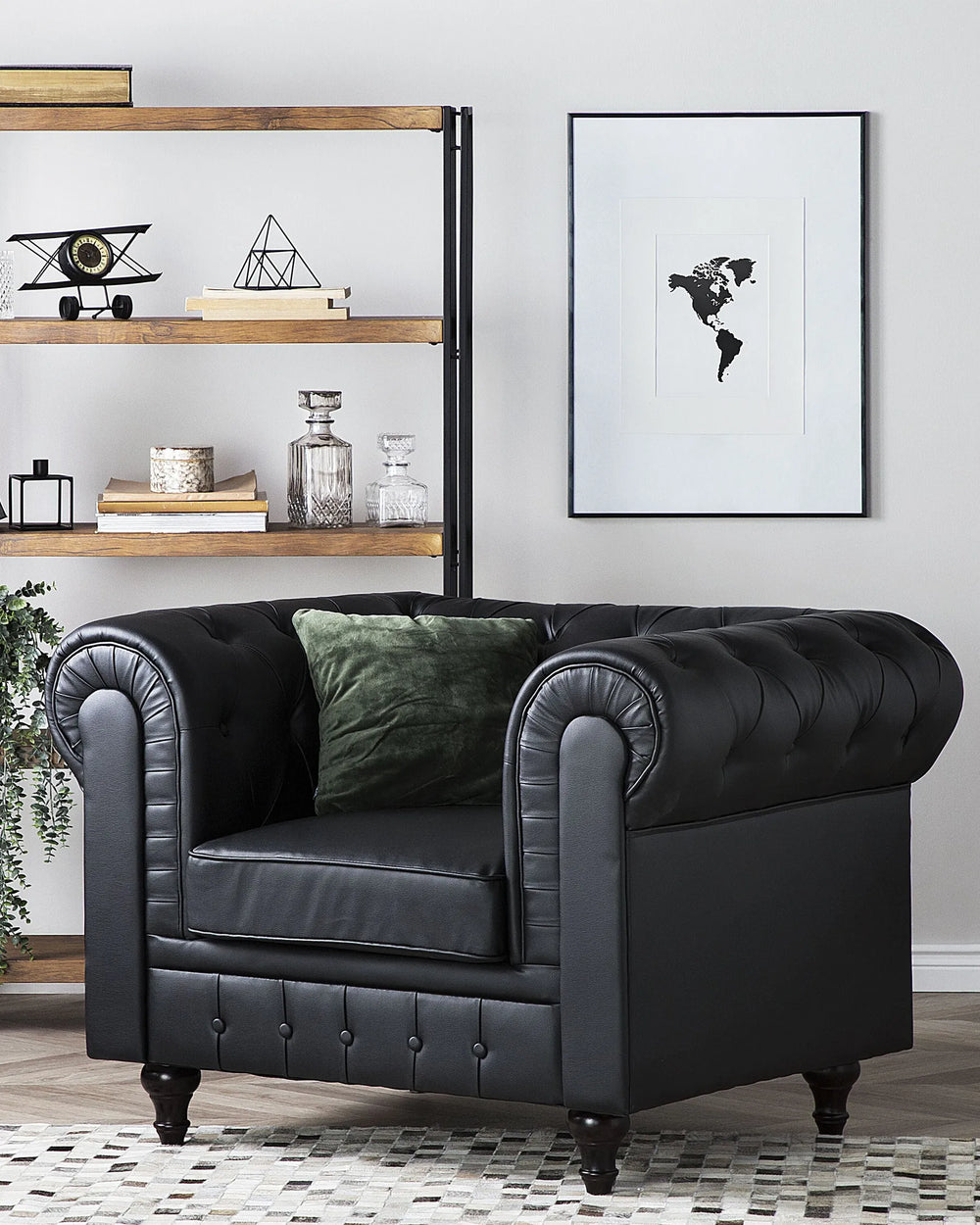 Black leather armchair in a living room setting with a world map poster on the wall.