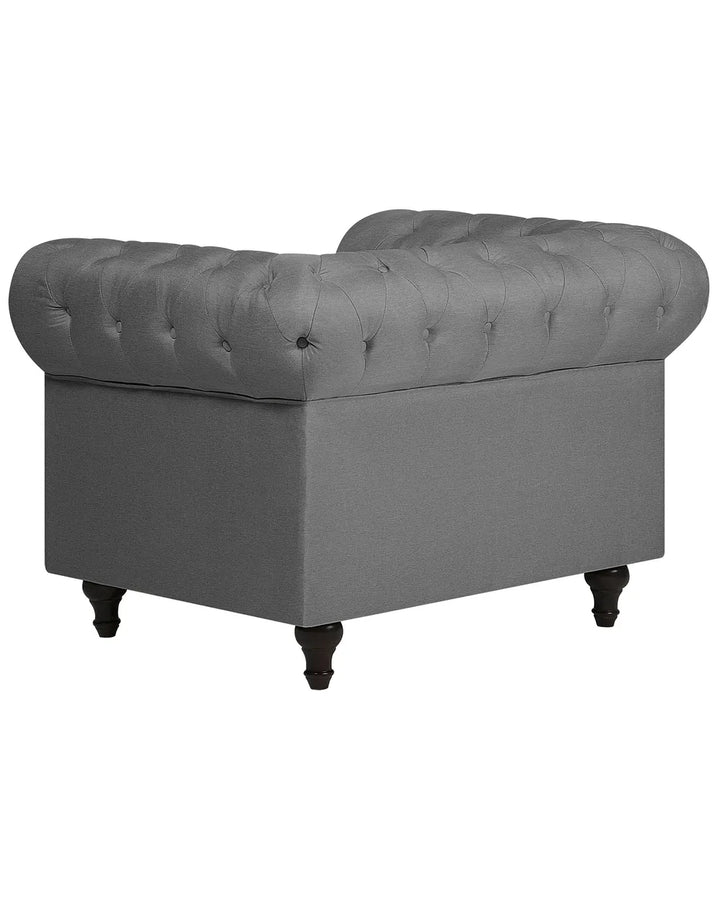 Gray tufted armchair on a white background