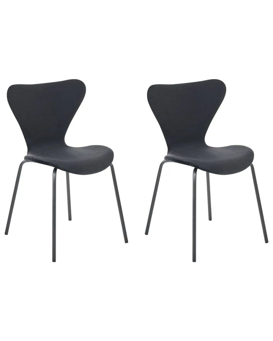 Two modern black dining chairs with sculptural curved seats and slim metal legs, shown side by side on a plain white background.