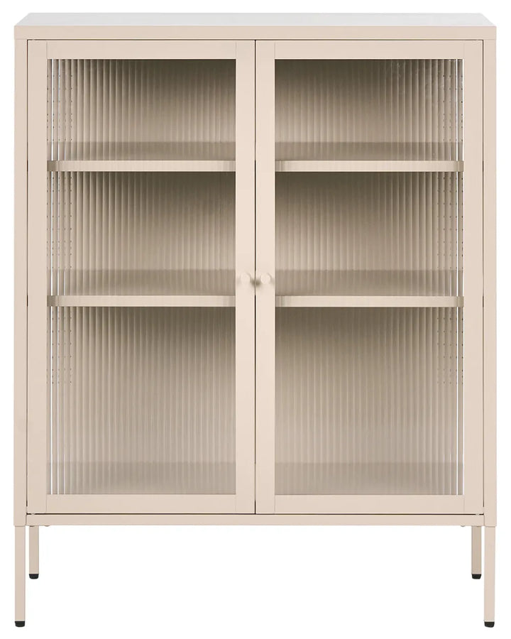 A tall, narrow storage cabinet with two doors featuring vertical ribbed glass panels and three interior shelves, finished in a light warm beige tone with slim metal legs.