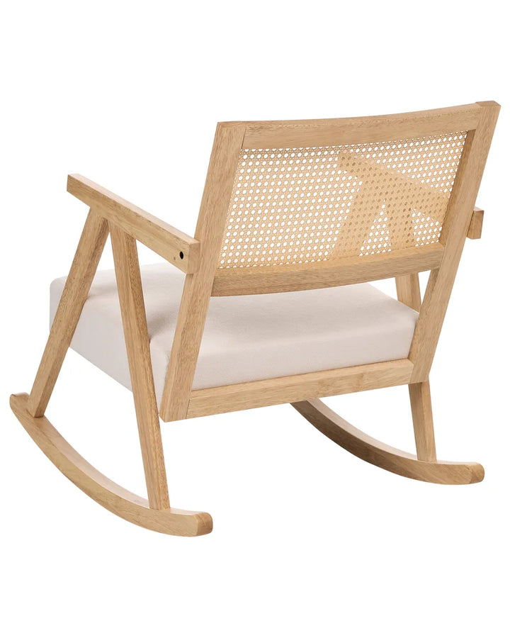 Wooden rocking chair with woven backrest and white cushion on a white background