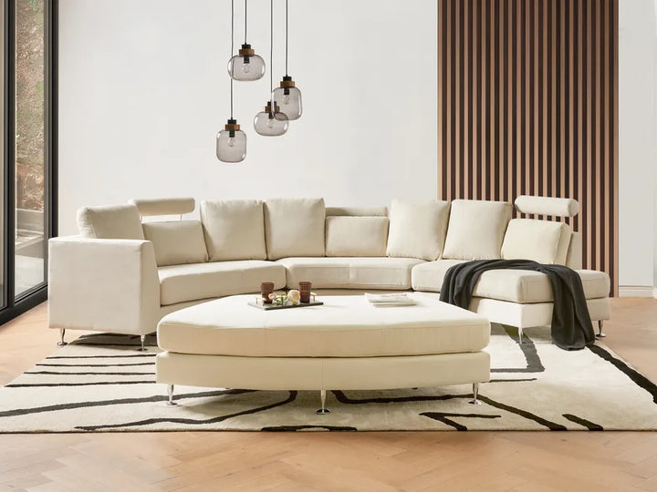 Large beige modular sofa with curved design