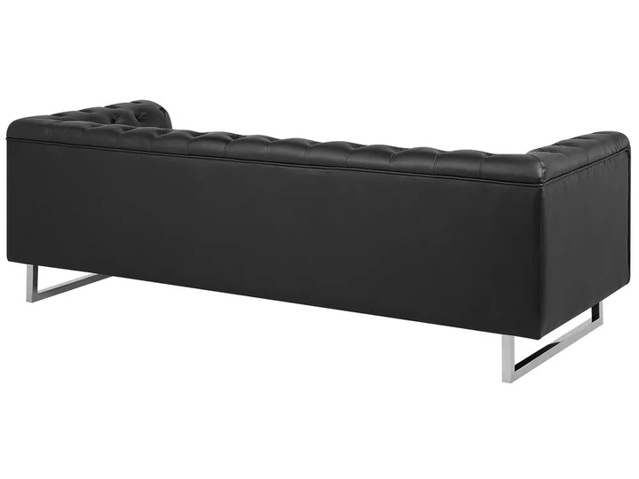 A modern black tufted leather sofa with slim chrome metal legs, shown from a three-quarters angle against a plain white background.