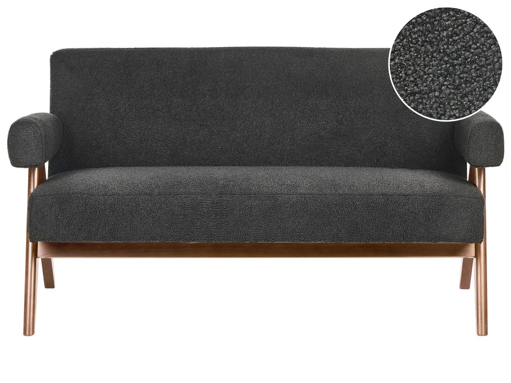 Green sofa with wooden legs on a white background