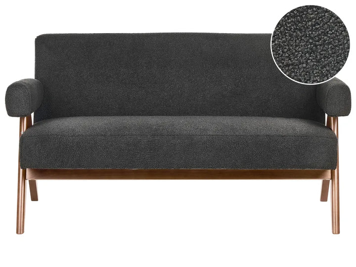 Green sofa with wooden legs on a white background