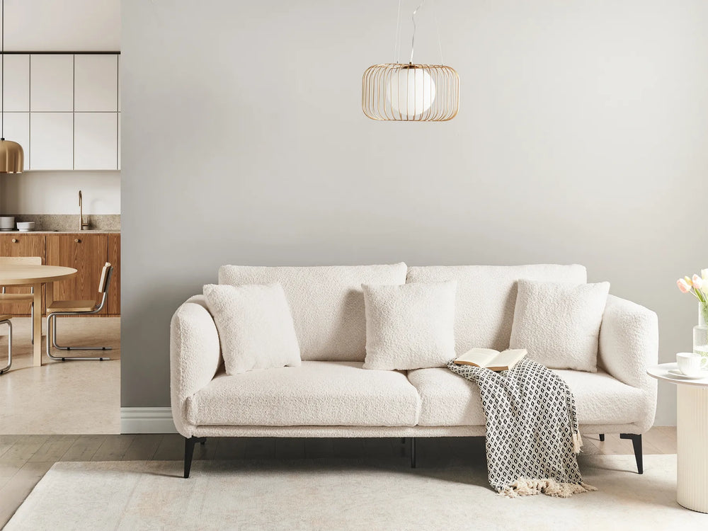 Beige sofa in a modern living room with a neutral color palette.