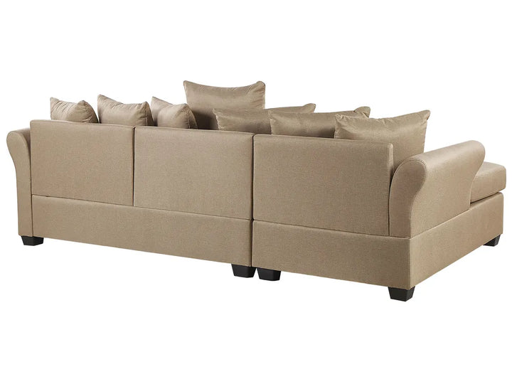 A beige fabric sectional sofa with multiple matching throw pillows, shown from a three-quarter angle against a plain white background.