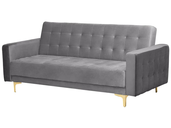 A modern gray velvet loveseat sofa with a tufted button design on the backrest and seat, supported by slim gold metal legs, shown against a plain white background.