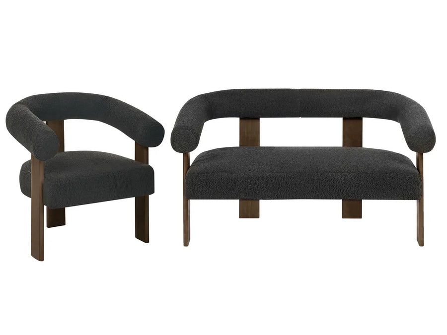 A matching upholstered seating set featuring a dark gray armchair and a curved bench with dark gray bouclé upholstery and medium brown wooden legs, shown against a plain white background.