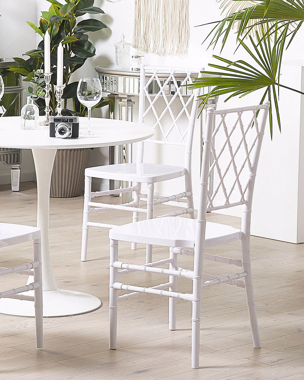 White chairs and table with decorative elements in a room setting