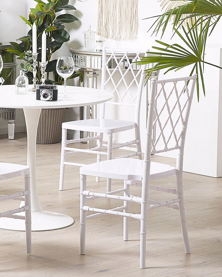 White chairs and table with decorative elements in a room setting