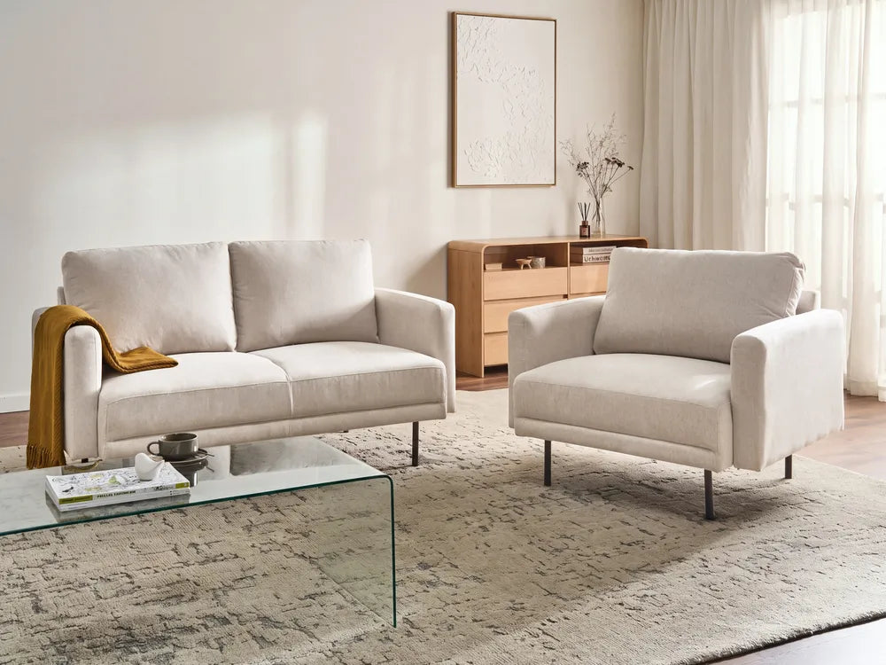 A modern two-seater sofa in a light beige textured fabric, featuring black metal legs, shown from a three-quarters angle