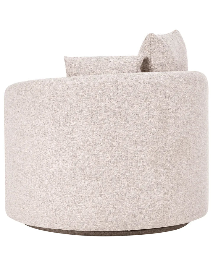A modern round upholstered accent chair in a light beige textured fabric, featuring a low cylindrical body, a matching back cushion, and a dark gray circular base, shown against a plain white background.