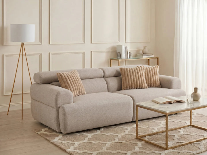 Beige upholstered three-seater sofa