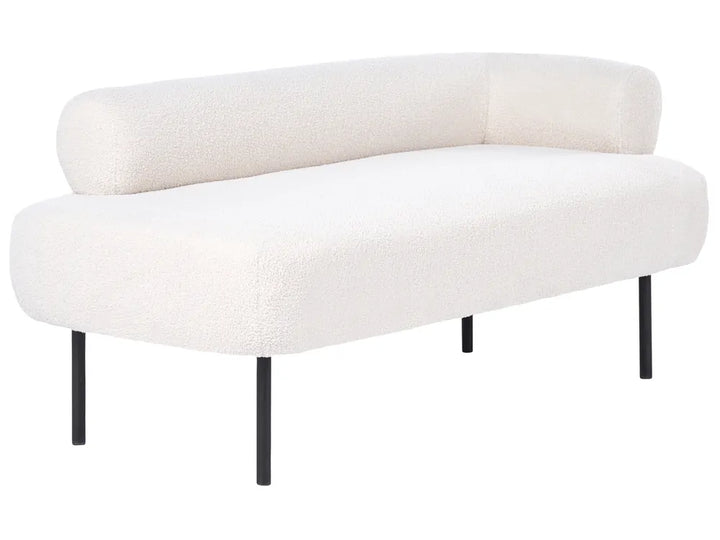 A modern curved lounge bench upholstered in textured off-white bouclé fabric with slim black metal legs, shown against a plain white background.