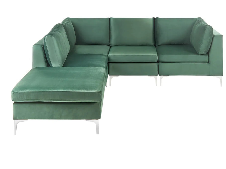 A modern L-shaped sectional sofa upholstered in textured sage green velvet, featuring a left-facing chaise lounge and slim white metal legs, shown against a plain white background.
