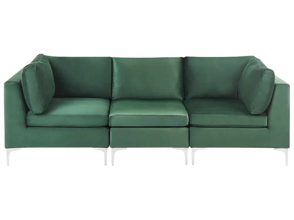 A modern three-seat sofa upholstered in a deep forest green velvet fabric, featuring slim white metal legs, shown against a plain white background.