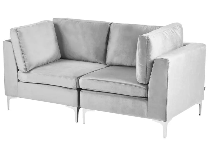 A modern two-seater sofa upholstered in light gray velvet, featuring slim white metal legs, shown against a plain white background.
