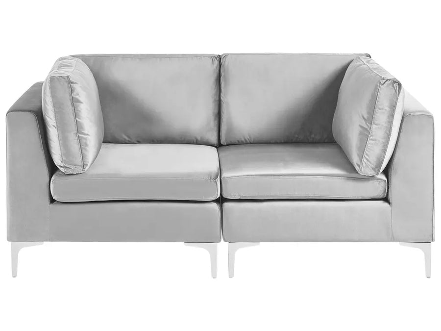 A modern two-seater sofa upholstered in light gray fabric with matching back cushions and slim white legs, shown against a plain white background.