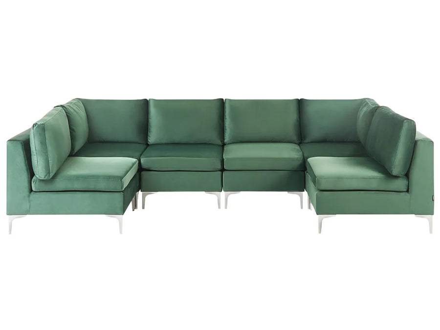 A modern sectional sofa upholstered in a textured sage green fabric, featuring a left-facing chaise lounge, a central three-seater section, and a right-facing chaise lounge, supported by slim white metal legs against a plain white background.
