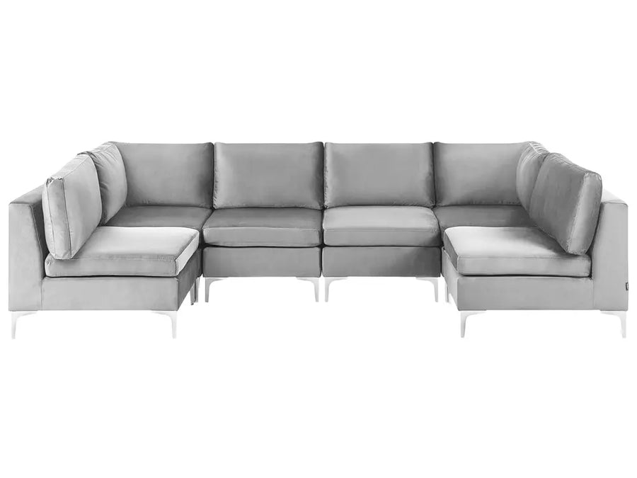 A modern light gray sectional sofa with a left-facing chaise lounge and a right-facing ottoman, supported by slim white legs, shown against a plain white background.