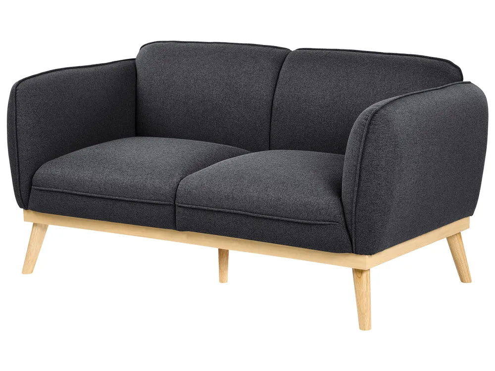 A modern two-seater sofa with dark charcoal gray textured fabric upholstery and light natural wood legs, shown on a plain white background.