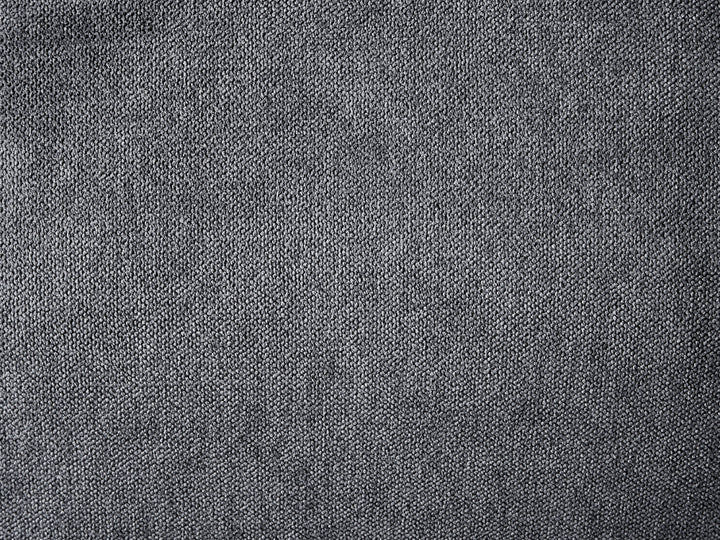 A close-up texture shot of a dark gray woven fabric, showing a fine knit or tweed pattern.