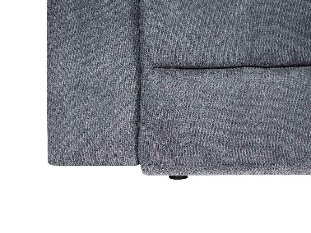 Close-up of a gray upholstered furniture corner showing the fabric texture and seam details against a white background.