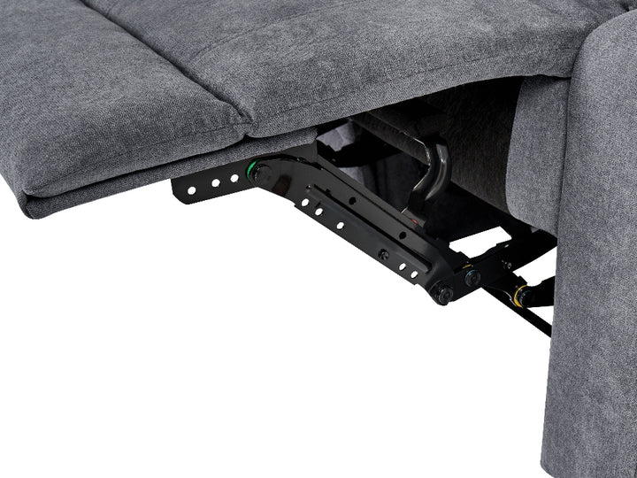 Close-up of a gray upholstered recliner chair showing the extended footrest and black metal reclining mechanism against a white background.
