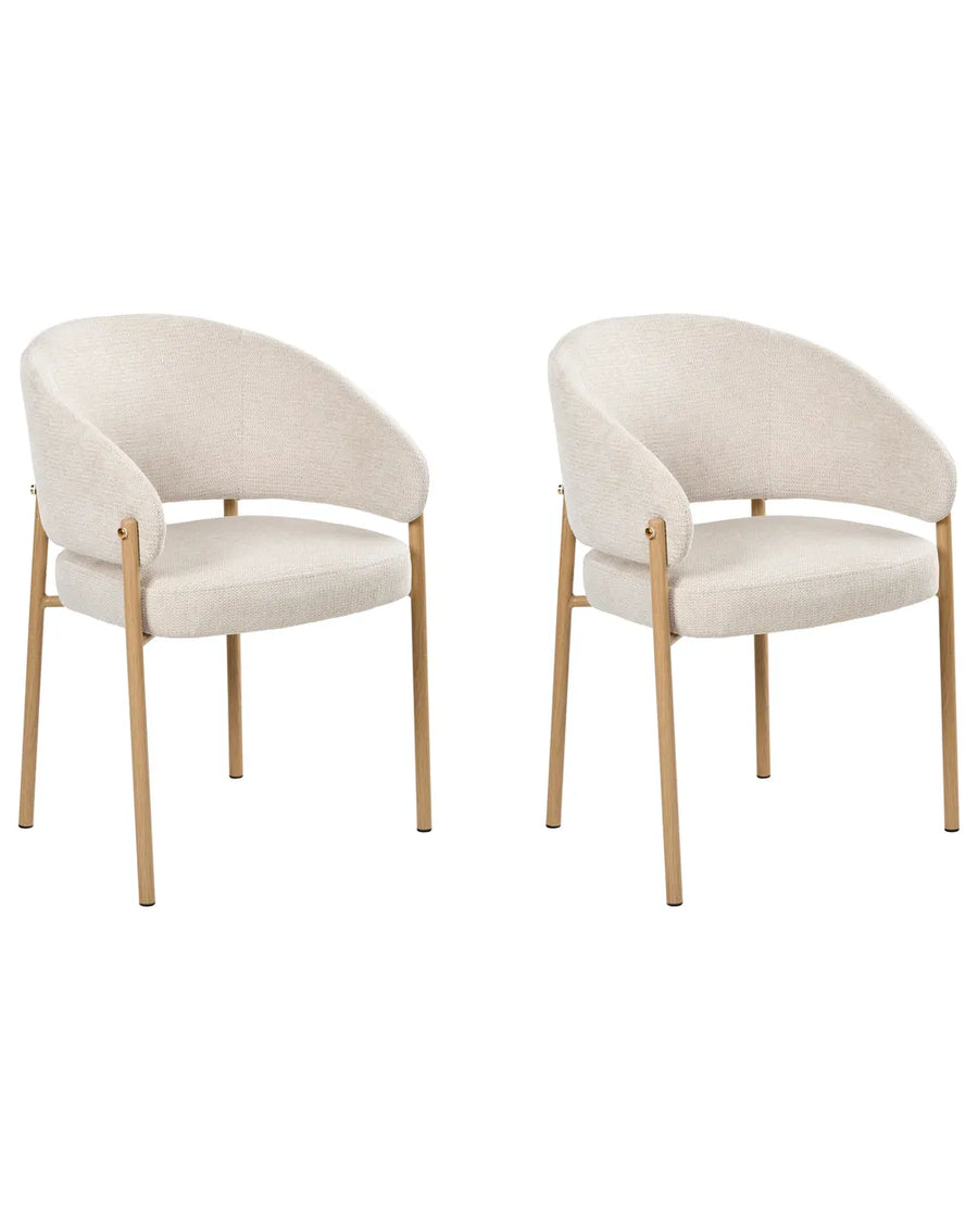 Two modern dining chairs with curved cream fabric upholstery and light natural wood legs, shown side by side on a plain white background.