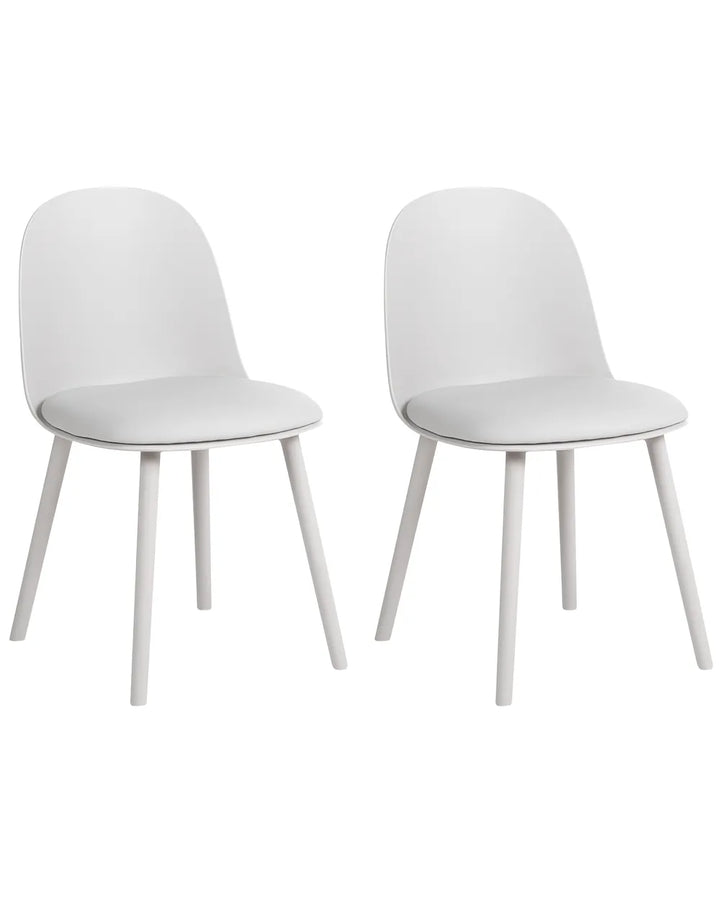 Two modern white dining chairs with curved backs and tapered legs, shown side by side on a plain white background.