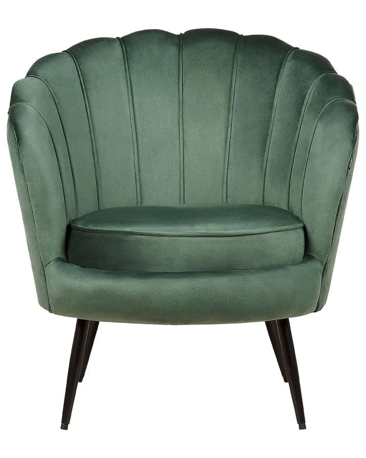 A green velvet accent chair with a scalloped shell-shaped backrest, dark wooden legs, and a cushioned seat, shown against a plain white background.