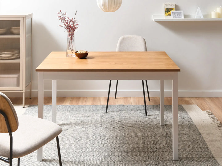 Wooden dining table with chairs in a room setting