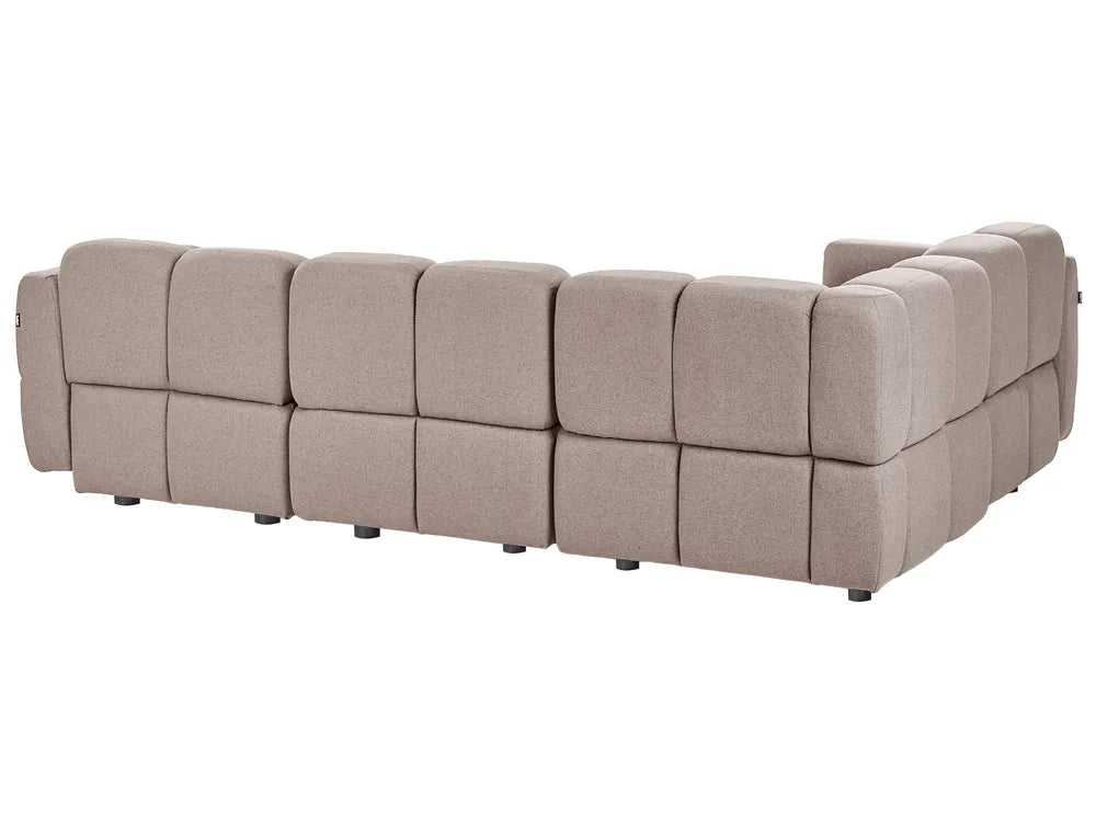 A modular upholstered sectional sofa with a low, blocky design and tufted square cushions, shown from a three-quarters angle against a plain white background.