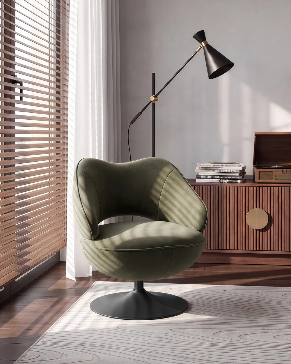 An olive green upholstered swivel armchair with a black pedestal base, styled in a modern room next to a window with wooden blinds, a black floor lamp, and a wooden cabinet.