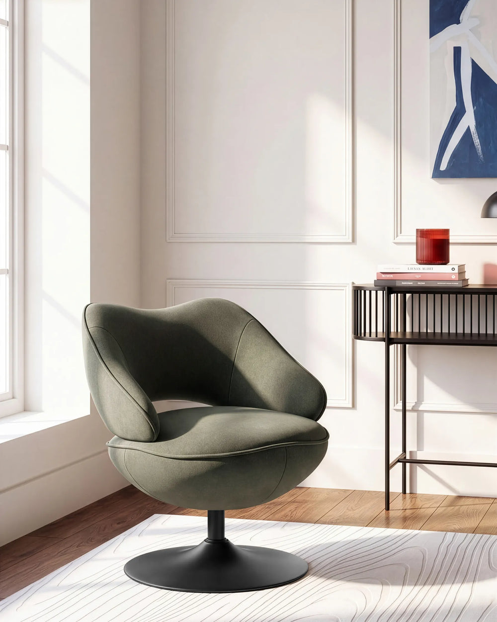 A modern swivel lounge chair in a muted sage green fabric with a black pedestal base, positioned in a bright, contemporary room with white walls, a window, and a side table.