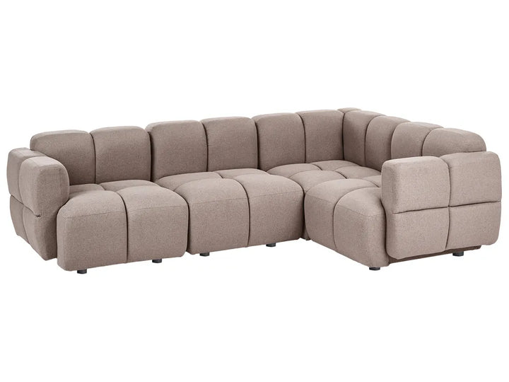 A modern modular sectional sofa upholstered in a textured taupe fabric, featuring a tufted grid pattern and blocky, padded arms, shown against a plain white background.
