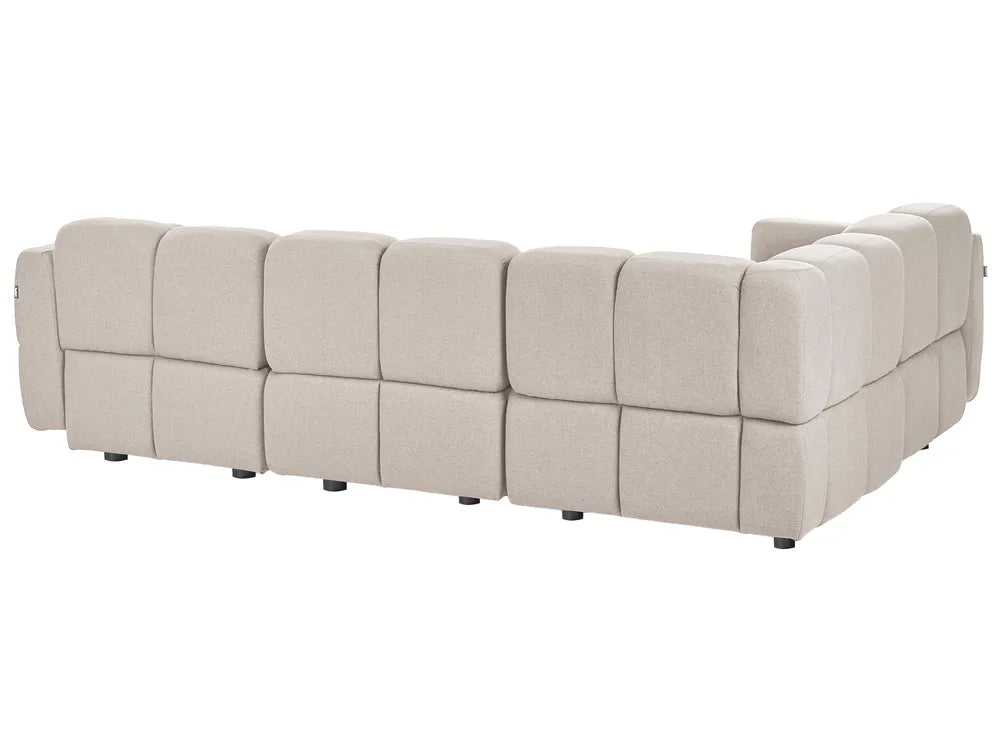 A modular upholstered sectional sofa with a low, blocky design and tufted square cushions, shown from a three-quarters angle against a plain white background.