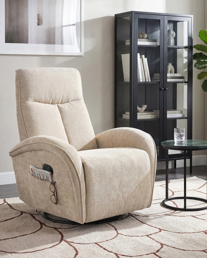Beige upholstered recliner chair with a swivel base in a styled living room setting next to a black glass display cabinet and a small round side table.