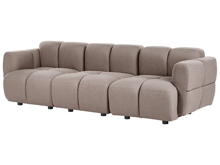 A modern modular sectional sofa upholstered in a textured taupe fabric, featuring a tufted grid pattern and low black legs, shown against a plain white background.