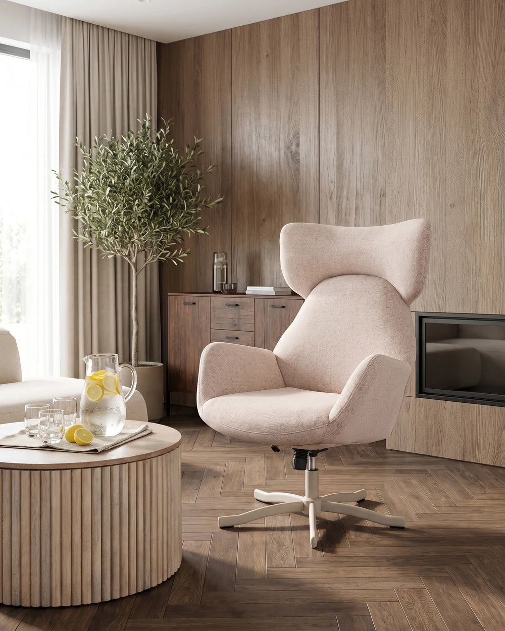 A modern blush pink upholstered swivel armchair with a high curved backrest and white star base, shown in a styled living room with wood-paneled walls, a round slatted coffee table, and a potted tree.