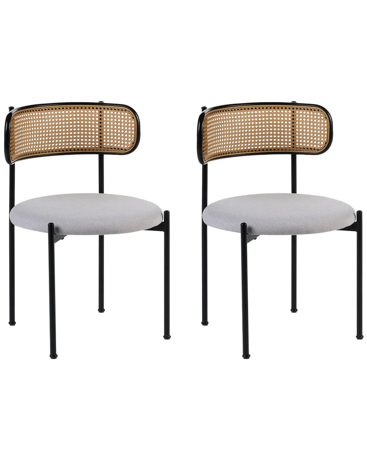Two matching dining chairs with light gray upholstered seats, natural woven cane backrests, and black metal frames, shown on a plain white background.