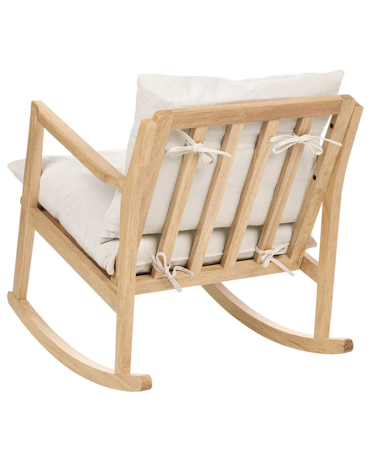 Wooden rocking chair with white cushions on a white background