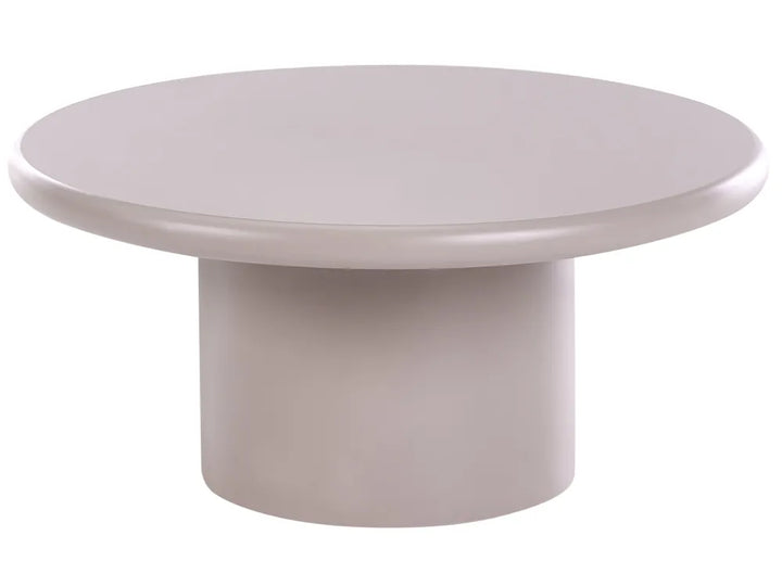 A minimalist round pedestal coffee table with a smooth, matte finish in a light taupe-gray color, isolated on a white background.