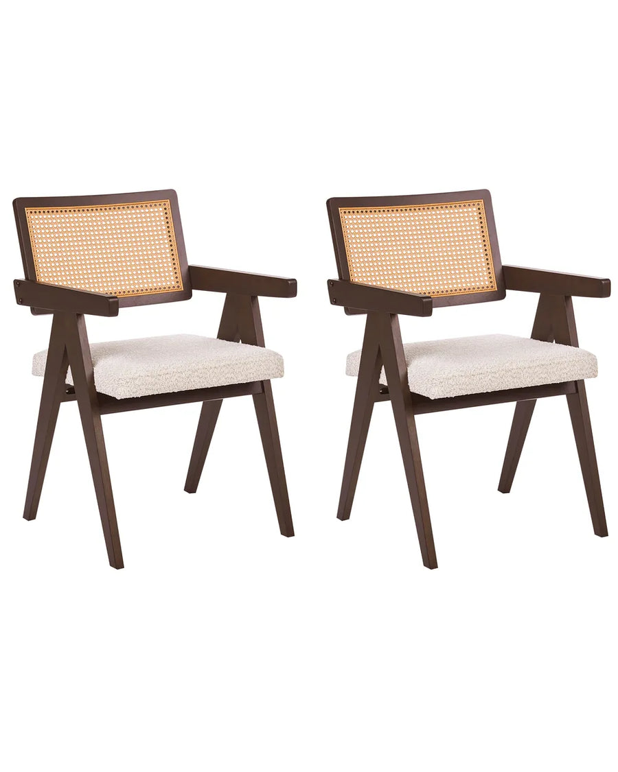 Two matching wooden dining armchairs with woven cane backrests and cream upholstered seats, shown on a plain white background.