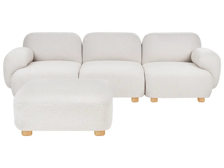 A modern three-seat sofa with a matching ottoman, upholstered in a textured cream bouclé fabric with light natural wood legs, shown against a plain white background.