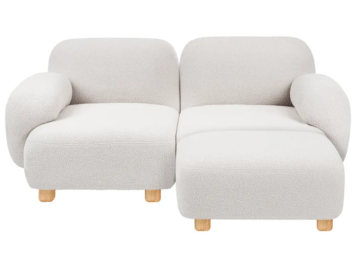 A modern two-seater sofa with rounded, bubble-like arms and a chaise lounge on the right, upholstered in a textured cream bouclé fabric and supported by small light wood legs, shown against a plain white background.