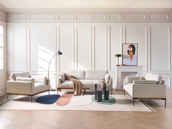 Modern living room with white furniture and decorative elements.